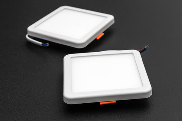 Two square led lamps on black background.