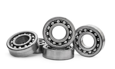 Heap of metal bearings on white.