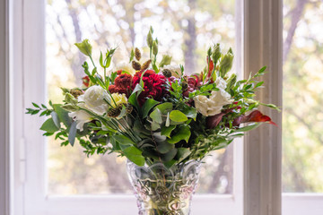 a gorgeous bouquet of the various flowers standing next to the window decorating the home interior design