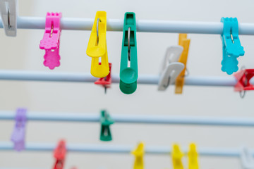 Fototapeta na wymiar many colorful pins hang on the clothes dryer in the laundry