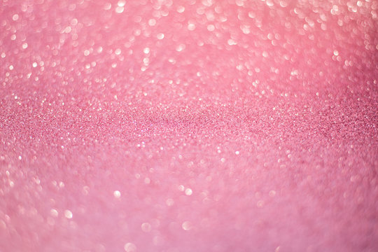 beautiful pink sequins on the glitter sparkle of sun light background with blur bright bokeh