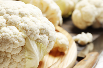 Fresh cauliflower close-up on a brown wooden table