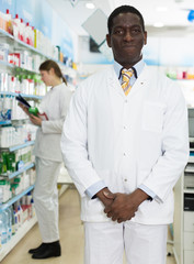 Naklejka na ściany i meble smiling man pharmacist of pharmacy