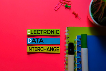 EDI. Electronic Data Interchange acronym on sticky notes. Office desk background