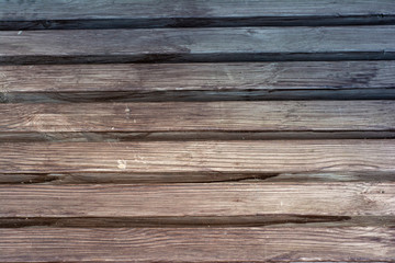 Obraz premium Background with a wall folded from wooden planks laid with an overlap for protection against rain