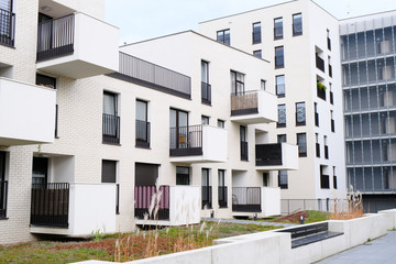 Cozy courtyard of modern apartment buildings district with white walls.