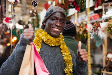 Laughing guy after shopping on Christmas market