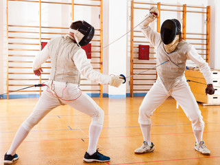 fencers at fencing workout, practicing attack movements
