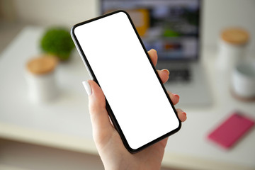 female hand holding phone with isolated screen in room