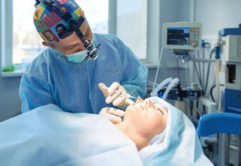Man surgeon at work in operating room
