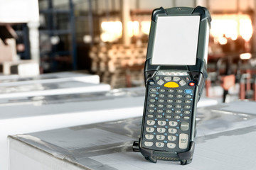 Bluetooth barcode scanner on packaging boxes at distribution warehouse.  
