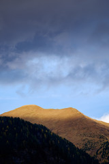 mountain ridge dramatic clouds blue sky