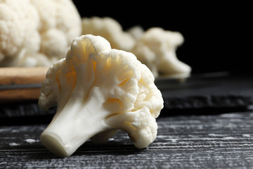 Fresh cauliflower close-up on a dark wooden background. Top view.