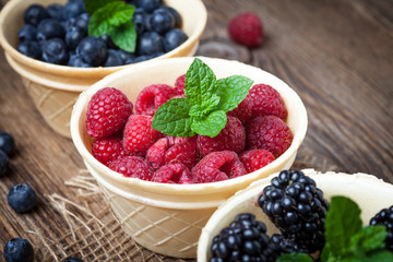 Blackberries, raspberries and blueberries in a waffle bowls.