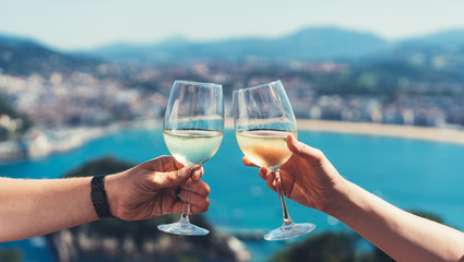 Drink two glasses white wine outdoor sea nature holidays, romantic couple toast with alcohol, happy people cheering fun vacation enjoying travel time together friendship love concept blure congrat