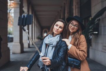 Girlfriends tourist taking photo selfie together on smartphone mobile. Blogger travels in europe city. Vacation holiday friendship concept. Travelers self on cellphone internet technology mockup space