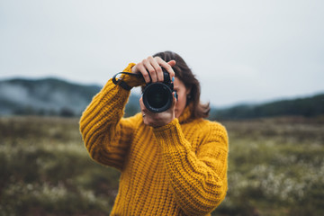 photographer tourist take photo on camera lens on background autumn foggy mountain, traveler...