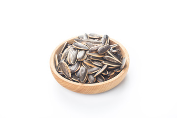 Sunflower seeds in wooden bowl isolated on white