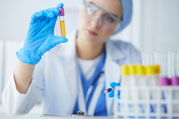 Laboratory assistant woman analyzing a blood sample