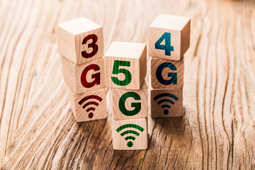 5G (5th Generation) network connecting technology future global. Hand flip wood cube change number 4G to 5G
