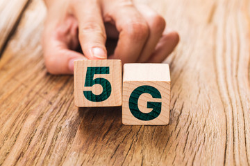 5G (5th Generation) network connecting technology future global. Hand flip wood cube change number 4G to 5G