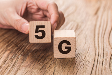 5G (5th Generation) network connecting technology future global. Hand flip wood cube change number 4G to 5G