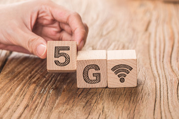 5G (5th Generation) network connecting technology future global. Hand flip wood cube change number 4G to 5G