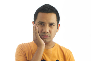 The man had a toothache and covered his cheek with his hand. He suffering from bad toothache. Isolated on white background, Copy space for text.