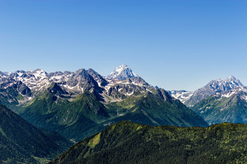 Fototapeta premium snowy peaks of the caucasian mountains on a summer day
