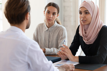 Asian muslim female hr manager interviewing applicant consulting client