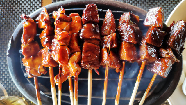 Indonesian grilled bbq meats with wooden skewers