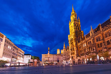 Fototapeta na wymiar Night view of the main attraction of Munich and all of Bavaria - illuminated building of the New Town Hall at night. Tourism and Travel to Germany concept