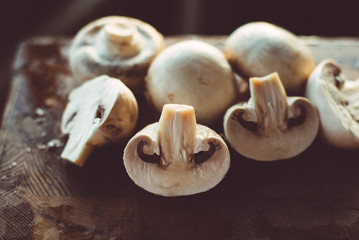 Sliced champignons on a chopping wooden board