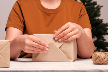 The girl is wrapping gifts. The concept of holiday, christmas, new year, surprise