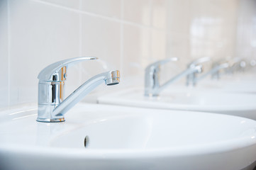 Close-up of row modern ceramic wash hand basins