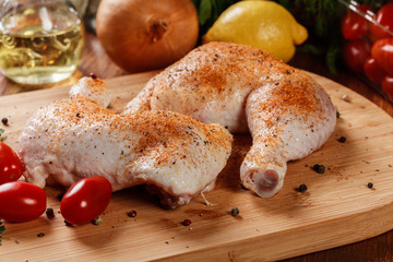 Raw chicken drumsticks seasoned with herbs