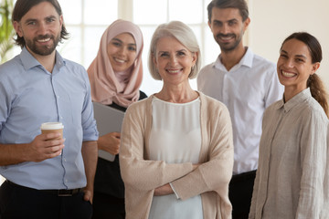 Cheerful company staff diverse business people standing in office, portrait