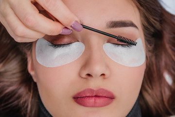 Eyelash Extension Procedure. Woman Eye with Long Blue Eyelashes. Close up, selective focus.Eyelash...