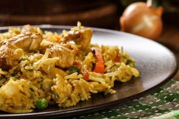 Fried rice nasi goreng with chicken and vegetables on a plate