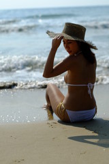 young happy woman in white bikini on  the beach