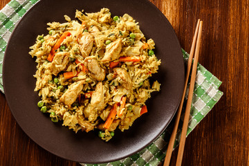 Fried rice nasi goreng with chicken and vegetables on a plate