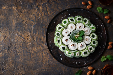 Turkish Delight. Assorted oriental sweets with nuts on a dark background.