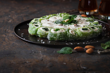Turkish Delight. Assorted oriental sweets with nuts on a dark background.