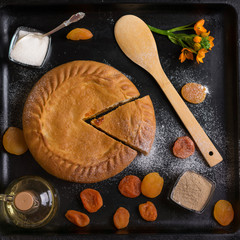authentic pie on a black background with ingredients