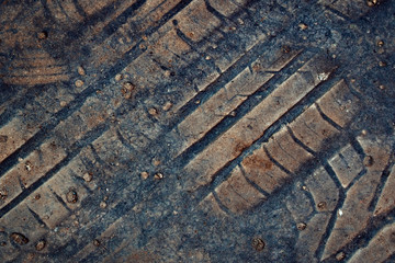 imprint of rubber tread pattern on old asphalt
