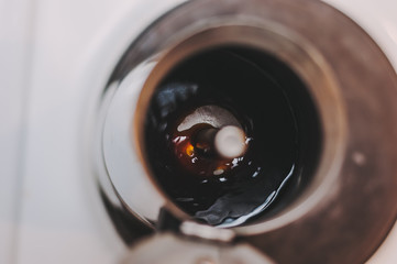 A cup of coffee maker is filled with fresh hot coffee