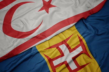waving colorful flag of madeira and national flag of northern cyprus.