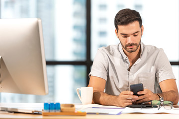 Businessman caucasian using  mobile to work with financial data in the modern office, relax and rest time after work.  Business Concept.
