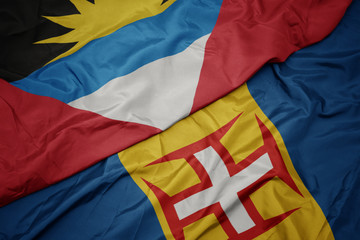 waving colorful flag of madeira and national flag of antigua and barbuda.