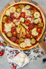 Home made fresh italian pizza with vegetable. Served on light stone table. Shot from upper view. Top view